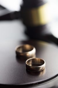 Judge's gavel and two wedding bands